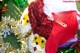 A red and white santa hat sitting on top of a pile of presents.